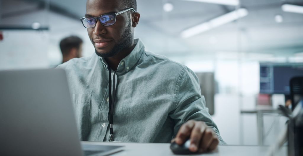 African American man working at a computer in an office